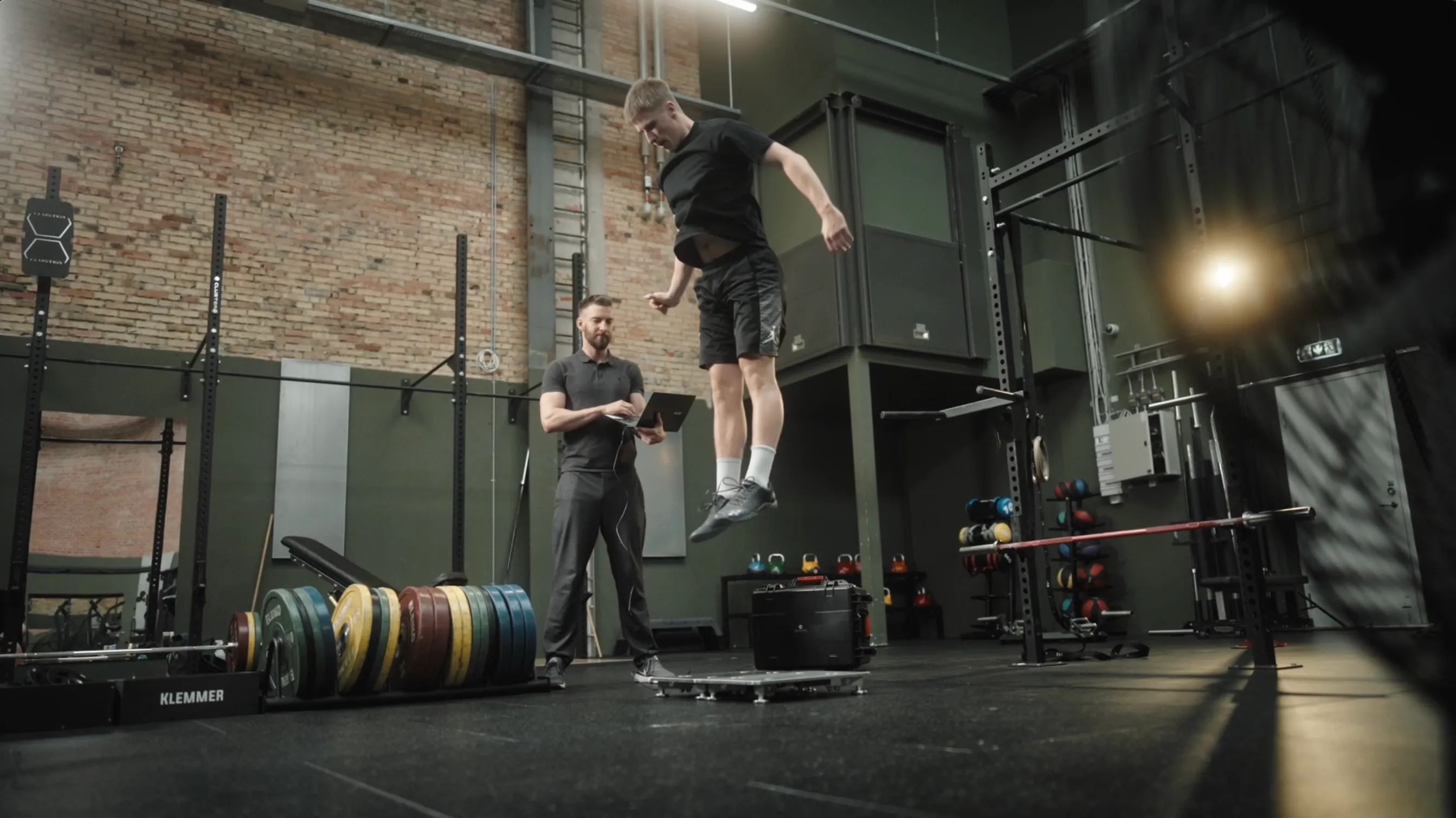 An athlete performing a countermovement jump on a PlateMate dual force plate