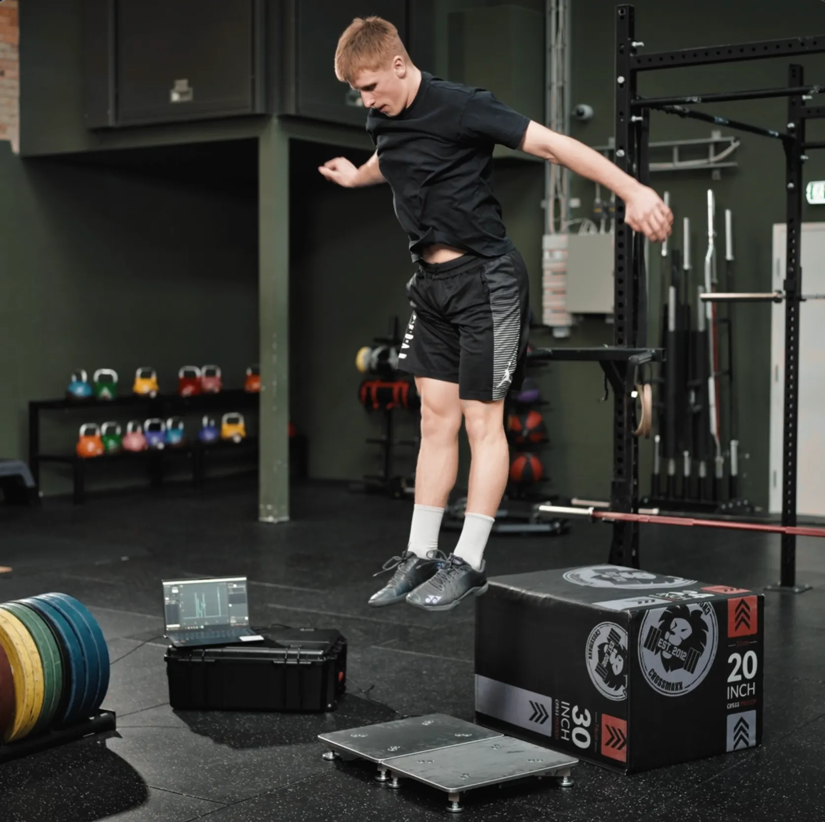 An athlete performing a drop jump, landing on a PlateMate force plate