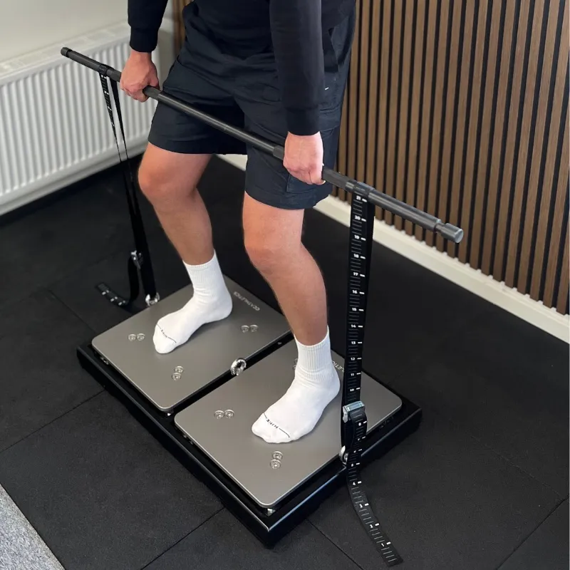 Athlete standing on PlateMate force plates in the IMTP Platform, pulling against the bar of the IMTP Extension