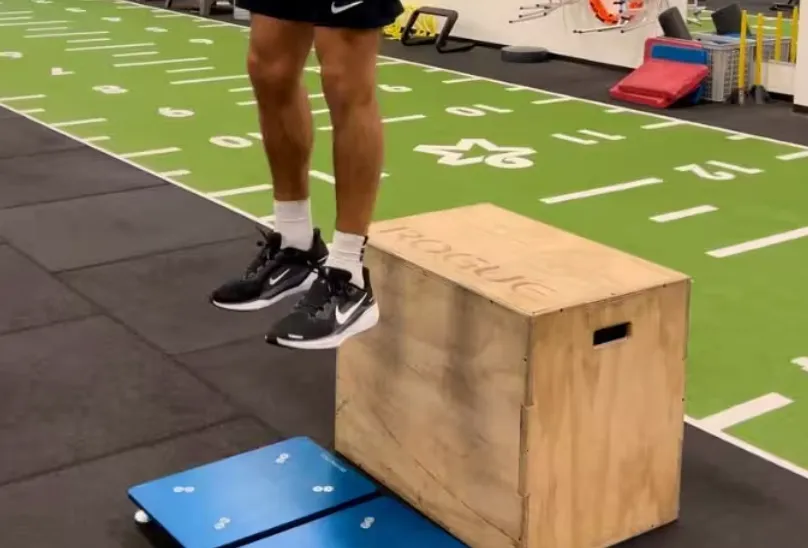 Athlete performing a drop-jump test onto PlateMate force plates