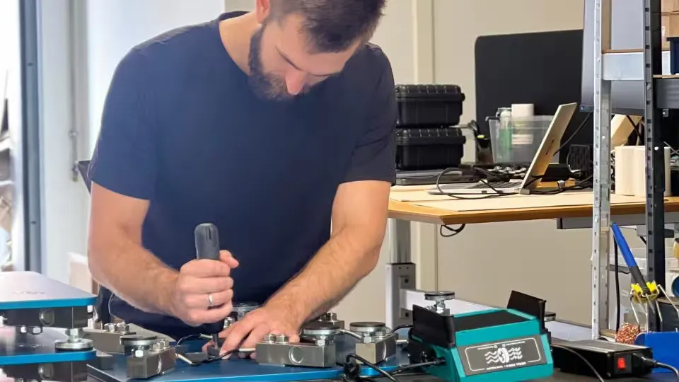 Ulrik hand-assembling force plates in the workshop